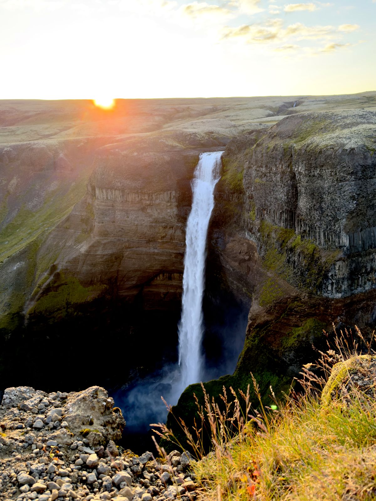 Háifoss waterfall dropping into a canyon at sunset